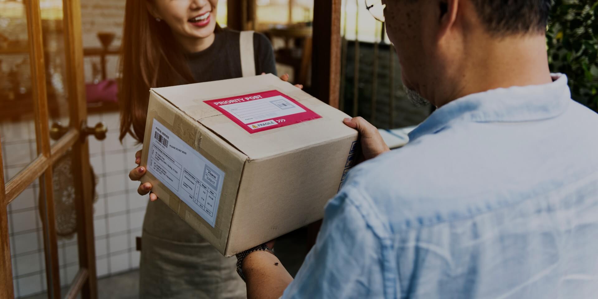 Woman receiving delivery order at her door