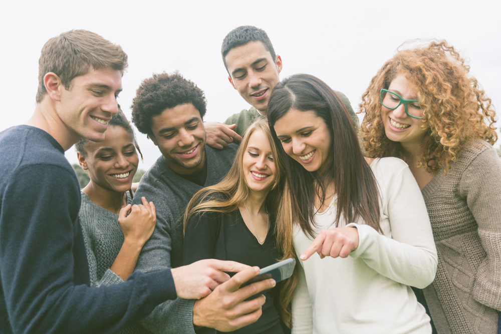 Multiethnic Group of Friends Looking at Mobile Phone