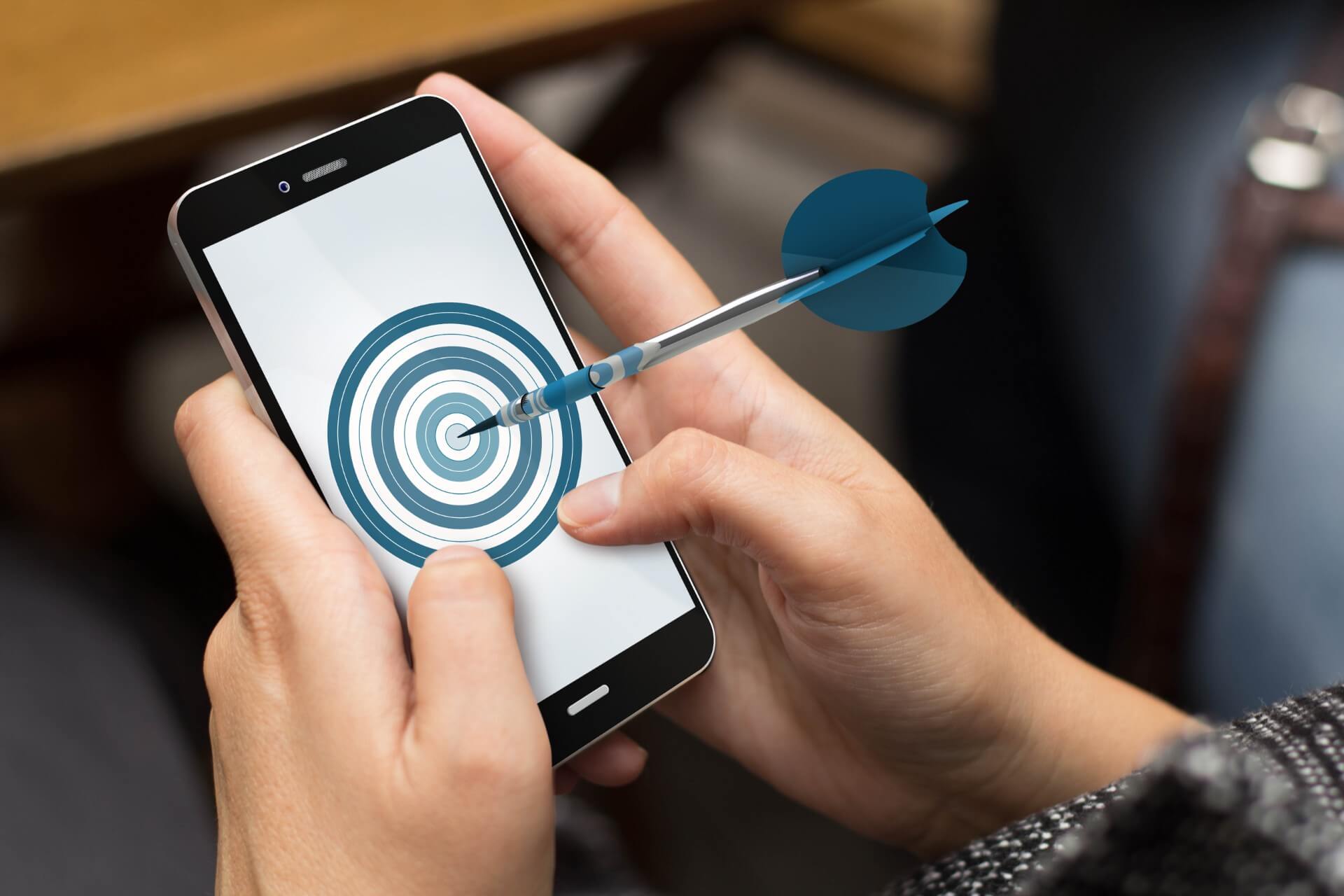 Girl using a smartphone with a target on the screen 